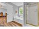 Bathroom featuring a separate tub and shower, with hardwood floors at 190 Crestworth Ct, Powder Springs, GA 30127