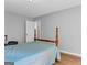 Bedroom with light gray walls, wood-look floors and a four-poster bed with a light blue comforter at 190 Crestworth Ct, Powder Springs, GA 30127