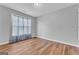 Bedroom with hardwood floors, large window, and neutral color scheme at 190 Crestworth Ct, Powder Springs, GA 30127