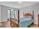Bedroom with hardwood floors, bed, and a window providing natural light at 190 Crestworth Ct, Powder Springs, GA 30127