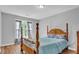 Bedroom featuring wood-look floors, natural light, gray walls and a wooden bed with a light blue comforter at 190 Crestworth Ct, Powder Springs, GA 30127