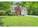 Traditional two-story home with brick accents and a well-manicured lawn, surrounded by trees at 190 Crestworth Ct, Powder Springs, GA 30127