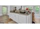 Bright kitchen with granite countertops, white cabinets, and an open view to the outdoors at 190 Crestworth Ct, Powder Springs, GA 30127