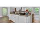 Bright kitchen featuring granite countertops, white cabinets, and stainless steel sink at 190 Crestworth Ct, Powder Springs, GA 30127