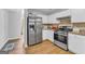 Modern kitchen with stainless steel appliances, white cabinetry, and granite countertops at 190 Crestworth Ct, Powder Springs, GA 30127