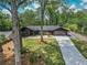 Aerial view showcasing a well-manicured lawn, a long driveway, and a contemporary home design nestled among mature trees at 2648 Varner Ne Dr, Atlanta, GA 30345