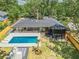 Aerial view of backyard featuring a pool with sun loungers, covered patio and manicured lawn at 2648 Varner Ne Dr, Atlanta, GA 30345