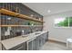 Custom bar area featuring stylish dark gray cabinetry, floating shelves, and sleek counter space at 2648 Varner Ne Dr, Atlanta, GA 30345