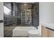 Black tiled bathroom featuring a tub/shower, toilet, and vanity at 2648 Varner Ne Dr, Atlanta, GA 30345
