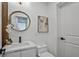 Bathroom with modern fixtures, stylish vanity, round mirror and neutral artwork at 2648 Varner Ne Dr, Atlanta, GA 30345