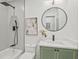 Stylish bathroom boasts modern fixtures, a round mirror, and a green vanity for a contemporary design at 2648 Varner Ne Dr, Atlanta, GA 30345