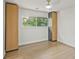 Bright bedroom showcasing a window view, hardwood floors, and custom storage cabinets at 2648 Varner Ne Dr, Atlanta, GA 30345