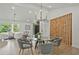 Dining room features glass table, modern chandelier, seating for six, and a decorative partition wall at 2648 Varner Ne Dr, Atlanta, GA 30345