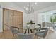 Dining area with modern chandelier, glass table and seating for six, and a decorative partition wall at 2648 Varner Ne Dr, Atlanta, GA 30345
