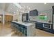 Modern kitchen featuring a large island with marble countertops, stainless steel appliances and stylish lighting fixtures at 2648 Varner Ne Dr, Atlanta, GA 30345