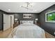 Cozy main bedroom with neutral decor, a modern light fixture, and a large window at 2648 Varner Ne Dr, Atlanta, GA 30345