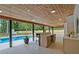 Inviting covered outdoor area with a bar, view of the pool, and lush greenery at 2648 Varner Ne Dr, Atlanta, GA 30345