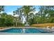Sparkling backyard pool with a modern fireplace feature, complemented by lush green trees and a privacy fence at 2648 Varner Ne Dr, Atlanta, GA 30345