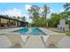 Backyard pool featuring sleek lounge chairs and an outdoor fireplace, perfect for relaxation and entertaining at 2648 Varner Ne Dr, Atlanta, GA 30345