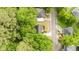 Aerial shot of house in wooded neighborhood showing street and neighboring houses at 306 Birch St, Canton, GA 30114