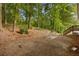 View of home backyard with stairs to door and a cozy outdoor seating area at 306 Birch St, Canton, GA 30114