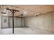 Spacious unfinished basement area showing concrete foundation and garage door at 306 Birch St, Canton, GA 30114