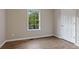 Bedroom with neutral colors, wood-look vinyl plank flooring and a white painted door at 306 Birch St, Canton, GA 30114