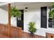 Inviting front porch with black door and decorative plants at 306 Birch St, Canton, GA 30114