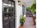 Close-up showcasing the inviting covered porch, stylish black door, and decorative potted plants at 306 Birch St, Canton, GA 30114