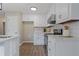 Bright kitchen with white cabinets, modern backsplash, and stainless-steel appliances at 306 Birch St, Canton, GA 30114
