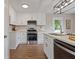 Bright kitchen featuring white cabinets, stainless steel appliances, and stylish backsplash at 306 Birch St, Canton, GA 30114