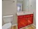 Cozy bathroom with red vanity, white sink, and ample storage at 3071 Springfair Trott, Lithonia, GA 30038