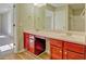 Bathroom featuring a double sink vanity with cherry-red cabinetry, and a view to a bedroom space at 3071 Springfair Trott, Lithonia, GA 30038