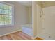 Bathroom featuring a soaking tub, separate tiled shower, and a bright window at 3071 Springfair Trott, Lithonia, GA 30038