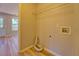 Small laundry room featuring laminate floors and utility connections for washer and dryer at 3071 Springfair Trott, Lithonia, GA 30038