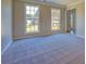 Bright living room featuring neutral carpet, large windows, and plenty of natural light at 3071 Springfair Trott, Lithonia, GA 30038
