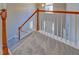 Upstairs view of carpeted staircase with white and wood banister at 3071 Springfair Trott, Lithonia, GA 30038