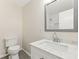 Bathroom featuring a white vanity with marble top, toilet, and a view of the shower at 3918 Oberlin Ct, Tucker, GA 30084