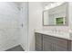 Beautiful bathroom with white marble shower, gray vanity, and chrome fixtures at 3918 Oberlin Ct, Tucker, GA 30084