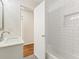 Modern bathroom with tiled shower/tub combo, marble countertop, and view into the hall at 3918 Oberlin Ct, Tucker, GA 30084