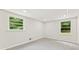 Bright bedroom with two windows, neutral walls and gray carpet flooring at 3918 Oberlin Ct, Tucker, GA 30084