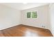 Clean, bright bedroom with hardwood floors, white walls, and a large window at 3918 Oberlin Ct, Tucker, GA 30084