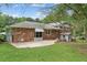 Back exterior view of brick home with awning-covered patio at 3918 Oberlin Ct, Tucker, GA 30084