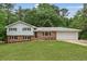 Charming split-level home featuring a brick facade, gray siding, and a well-manicured lawn at 3918 Oberlin Ct, Tucker, GA 30084