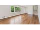 Light-filled living room with hardwood floors and view of entry stairs and front yard through large window at 3918 Oberlin Ct, Tucker, GA 30084