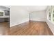 Bright, empty living room featuring gleaming hardwood floors and large windows at 3918 Oberlin Ct, Tucker, GA 30084