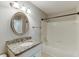 Bathroom with tub shower, granite vanity and decorative mirror at 4106 Santa Fe Pkwy, Atlanta, GA 30350