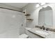 Updated bathroom with tub shower combo, granite vanity and decorative shelving at 4106 Santa Fe Pkwy, Atlanta, GA 30350
