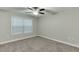 Cozy bedroom with neutral carpet, a ceiling fan, and a large window at 4106 Santa Fe Pkwy, Atlanta, GA 30350