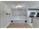 Bright dining area features built-in bench, modern lighting, and a view of the kitchen at 4106 Santa Fe Pkwy, Atlanta, GA 30350